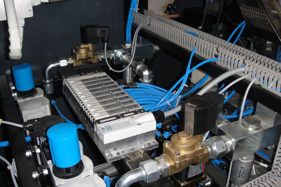 Combi 200 - Close-up of the pneumatic and control components inside a bottle blowing machine..